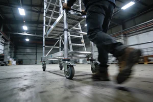 Mobile scaffolding tower on warehouse floor